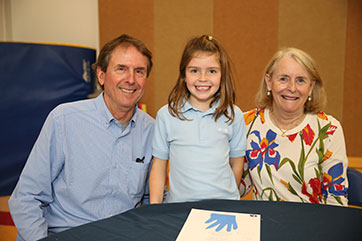 Photo of a student with her grandparents. Link to Life Stage Gift Planner Over Age 65 Situations.
